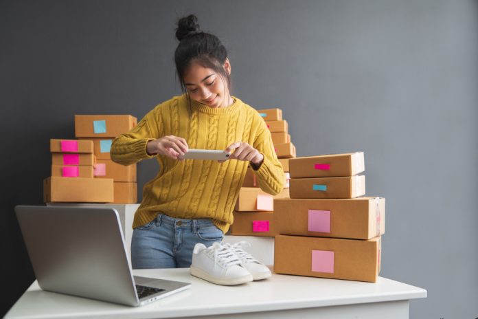 Young women taking photo to shoes with cell telephone or smartph